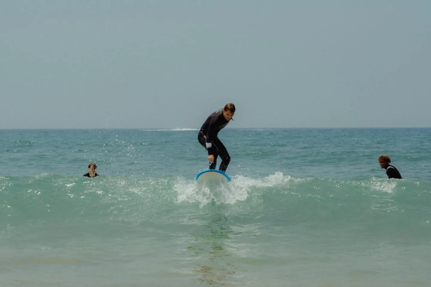Surfer riding whitewater near the shore
